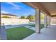 Covered patio overlooking a sparkling pool and grassy area at 11506 E Sylvan Ave, Mesa, AZ 85212