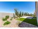 Landscaped backyard with artificial turf and stone at 1176 E Ridgerock St, Casa Grande, AZ 85122