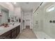 Elegant bathroom featuring double sinks and a frameless shower at 1176 E Ridgerock St, Casa Grande, AZ 85122