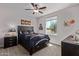 Bright bedroom with a ceiling fan and large window at 1176 E Ridgerock St, Casa Grande, AZ 85122