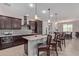 Open concept kitchen with dark cabinets and granite countertops at 1176 E Ridgerock St, Casa Grande, AZ 85122