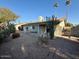 Backyard view, gravel, cacti, and a covered patio at 11808 S Half Moon Dr, Phoenix, AZ 85044