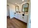 Modern bathroom with double vanity and a large mirror at 11808 S Half Moon Dr, Phoenix, AZ 85044