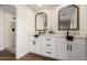 Modern bathroom with white cabinets, double vanity, and a walk-in shower at 11808 S Half Moon Dr, Phoenix, AZ 85044