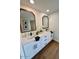 Double vanity bathroom with white cabinets and gold mirrors at 11808 S Half Moon Dr, Phoenix, AZ 85044