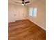 Bright bedroom with wood-look flooring and ceiling fan at 11808 S Half Moon Dr, Phoenix, AZ 85044