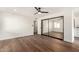 Spacious bedroom featuring mirrored closet doors and hardwood floors at 11808 S Half Moon Dr, Phoenix, AZ 85044