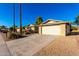 View of the home's exterior, highlighting the driveway and garage at 11808 S Half Moon Dr, Phoenix, AZ 85044