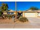 House exterior showcasing a two-car garage and drought-tolerant landscaping at 11808 S Half Moon Dr, Phoenix, AZ 85044