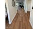 Bright hallway with light wood laminate flooring at 11808 S Half Moon Dr, Phoenix, AZ 85044