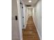 Long hallway with light walls and wood flooring at 11808 S Half Moon Dr, Phoenix, AZ 85044