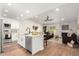 Remodeled kitchen with island, stainless steel appliances, and white shaker cabinets at 11808 S Half Moon Dr, Phoenix, AZ 85044