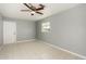 Empty bedroom with tile floors and ceiling fan at 132 W Beautiful Ln, Phoenix, AZ 85041