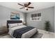 Comfortable bedroom with a ceiling fan and stylish decor at 132 W Beautiful Ln, Phoenix, AZ 85041