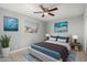 Comfortable bedroom with a ceiling fan and stylish decor at 132 W Beautiful Ln, Phoenix, AZ 85041