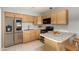 Modern kitchen with light wood cabinets and stainless steel appliances at 132 W Beautiful Ln, Phoenix, AZ 85041