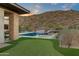 Luxury backyard oasis with a pool, putting green, and mountain views at 14245 N Territory Trl, Fountain Hills, AZ 85268