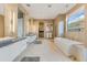 Spa-like bathroom with double vanity, soaking tub, and stone wall at 14245 N Territory Trl, Fountain Hills, AZ 85268