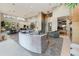 Open floor plan with a curved sofa and views into the kitchen and dining area at 14245 N Territory Trl, Fountain Hills, AZ 85268