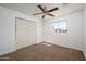 Bright bedroom with ceiling fan and large closet at 14626 N 36Th Pl, Phoenix, AZ 85032