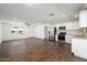 Open living room with dark brown tile floor and a view into the kitchen at 14626 N 36Th Pl, Phoenix, AZ 85032