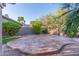 Backyard patio featuring stone and shrubbery, as well as a privacy wall, trees, and mountain views at 15237 S 19Th Way, Phoenix, AZ 85048