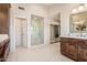 Bright bathroom with glass enclosed shower, double vanities, and modern finishes at 15237 S 19Th Way, Phoenix, AZ 85048