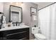 Well-lit bathroom featuring a sleek vanity, modern fixtures, and a shower with a white curtain at 15237 S 19Th Way, Phoenix, AZ 85048