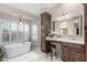 Elegant bathroom with a freestanding tub, vanity area, and natural light from the window at 15237 S 19Th Way, Phoenix, AZ 85048
