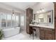 Spa-like bathroom with a large soaking tub and a double vanity at 15237 S 19Th Way, Phoenix, AZ 85048