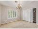 Simple bedroom with neutral walls, a closet, a chandelier, shutters, and carpet flooring at 15237 S 19Th Way, Phoenix, AZ 85048