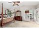 Main bedroom with a post bed, mirrored dresser and access to home gym at 15237 S 19Th Way, Phoenix, AZ 85048