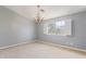 Bedroom featuring a window with plantation shutters and a chandelier, allowing for natural light at 15237 S 19Th Way, Phoenix, AZ 85048