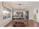 Open-concept dining area showcasing dark wood floors, modern lighting, and backyard views at 15237 S 19Th Way, Phoenix, AZ 85048