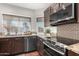 Modern kitchen with stainless steel appliances and granite countertops at 15237 S 19Th Way, Phoenix, AZ 85048