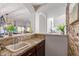 Kitchen with granite countertops, stone accents and a view into a naturally lit living space at 15237 S 19Th Way, Phoenix, AZ 85048