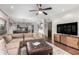 Spacious living room featuring a large sectional sofa and a flat-screen TV at 15237 S 19Th Way, Phoenix, AZ 85048