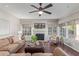 Comfortable living room boasting a fireplace, plush seating, hardwood floors, and abundant natural light at 15237 S 19Th Way, Phoenix, AZ 85048