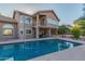 Backyard pool featuring attached patio and a two-story home with a balcony and desert landscaping at 15237 S 19Th Way, Phoenix, AZ 85048