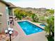 Inviting pool area with spa, palm trees, and mountain views at 15237 S 19Th Way, Phoenix, AZ 85048