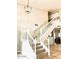 Elegant staircase with white railings leading to the upper level at 15237 S 19Th Way, Phoenix, AZ 85048