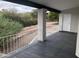 Covered patio with dark tile flooring and a white door, overlooking the backyard at 15869 E Ponderosa Dr, Fountain Hills, AZ 85268