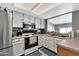 Galley kitchen with white cabinets and modern appliances at 1604 W Kerry Ln, Phoenix, AZ 85027