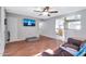 Living room with hardwood floors, a large TV, and comfy couch at 1604 W Kerry Ln, Phoenix, AZ 85027