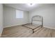 Bedroom with wood-look floors and window with blinds at 1637 W Tierra Buena Ln, Phoenix, AZ 85023