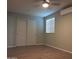 Spacious bedroom with double doors and wood-look flooring at 1637 W Tierra Buena Ln, Phoenix, AZ 85023