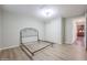 Empty bedroom with wood-look floors and double doors at 1637 W Tierra Buena Ln, Phoenix, AZ 85023