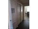 Clean hallway with doors and dark laminate flooring at 1637 W Tierra Buena Ln, Phoenix, AZ 85023