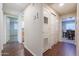 Hallway with light walls, wood flooring and access to bedrooms and bathroom at 1637 W Tierra Buena Ln, Phoenix, AZ 85023