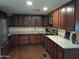 Modern kitchen with granite countertops and dark wood cabinets at 1637 W Tierra Buena Ln, Phoenix, AZ 85023